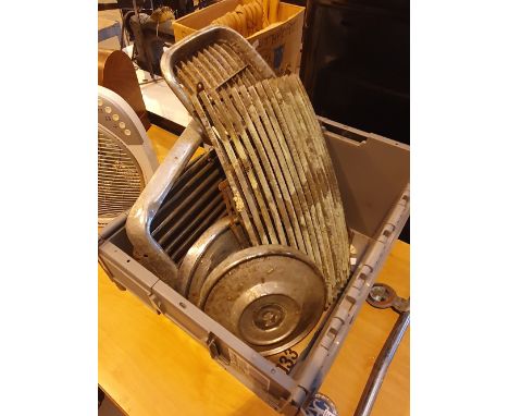 Box of vintage car radiator grills and two Daimler hub caps