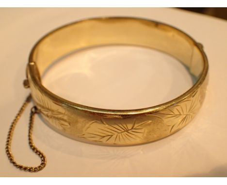 Rolled gold Excalibur bangle with floral engraving and safety chain