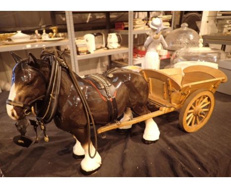 Large brown ceramic horse with wooden cart