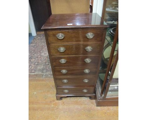 A GEORGIAN MAHOGANY TALLBOY of seven long graduated drawers with brass drop handles on bracket feet
