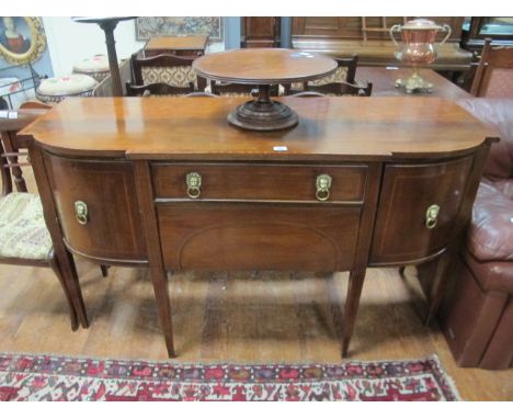 A GOOD REGENCY MAHOGANY BOW FRONT SIDEBOARD with satinwood cross banding and brass mask handles 163cm wide