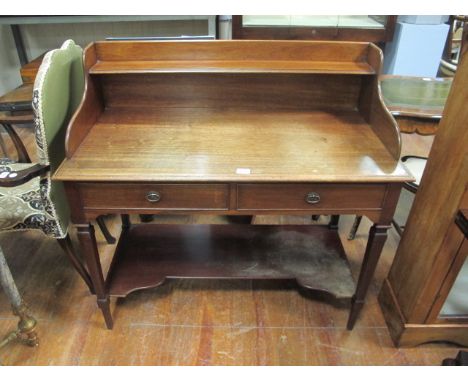 AN EDWARDIAN MAHOGANY SIDE TABLE the super structure with moulded shelf above two frieze drawers on square tapering legs join