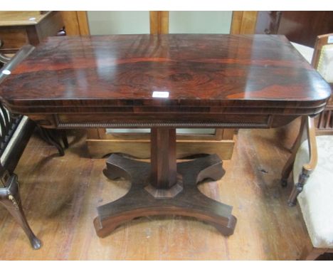 A REGENCY ROSEWOOD FOLD OVER CARD TABLE on octagonal pillar and platform base 92cm wide