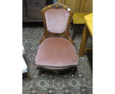 A VICTORIAN WALNUT NURSING CHAIR with carved decoration bow seat and turned tapering legs