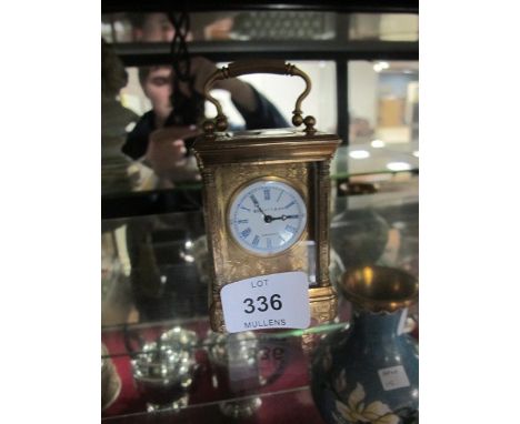 A MINIATURE BRASS ENGRAVED CASE CARRIAGE CLOCK the enamel dial with Roman numerals inscribed "Elliot and Son London"