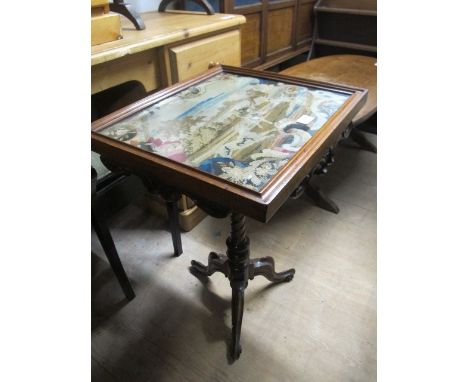 A VICTORIAN MAHOGANY OCCASIONAL TABLE the rectangular top with needlework panel above a carved apron on spiral twist support 