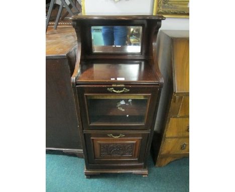 AN EDWARDIAN MAHOGANY MUSIC CABINET the super structure with open compartment and mirror back above two hinged compartments o