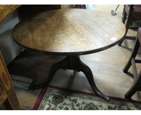 AN OAK COFFEE TABLE 19th Century the circular moulded top raised on tripod support with pad feet 57cm (h) x 73cm (d)