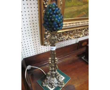 A MOULDED BRASS TABLE LAMP with berry shade 59cm high