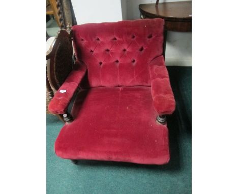 A VICTORIAN MAHOGANY ARMCHAIR with deep button upholstered back and seat on turned legs