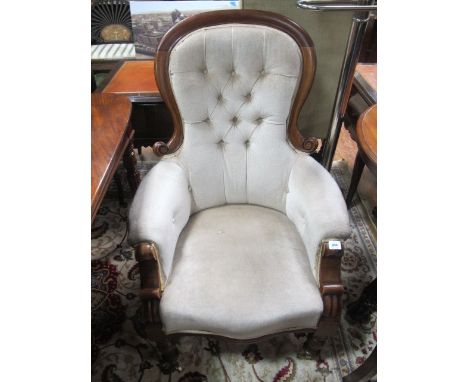 A VICTORIAN MAHOGANY GENTS CHAIR the arched top rail above a button upholstered back and seat on turned legs