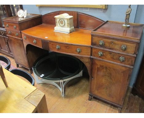 A GEORGIAN MAHOGANY PEDESTAL SIDEBOARD of rectangular bowed outline with two frieze drawers and pedestals containing two shor