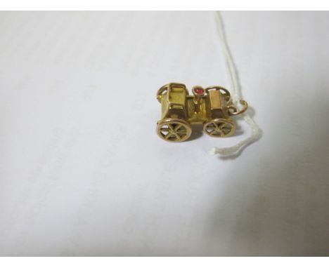 AN 9CT GOLD AND RUBY PENDANT modelled as a vintage car