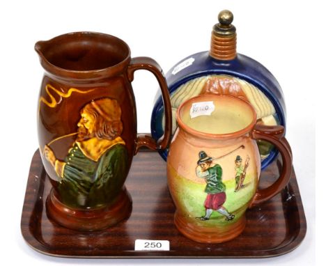 A Doulton Lambeth pottery flask decorated with Harry Simeon; a Royal Doulton golfing mug; and a Royal Doulton smokers jug (3)