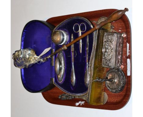 A Georgian silver wooden handled ladle, a case containing silver mounted manicure set, silver mounted combs, three plated spi