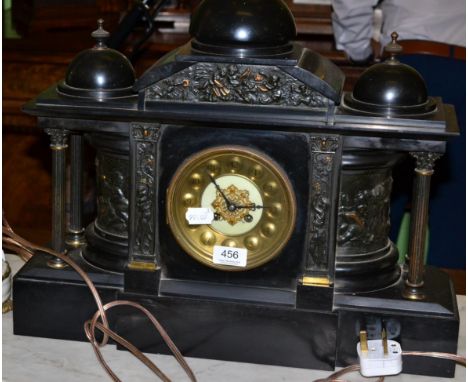 A Victorian black slate striking mantel clock of architectural form 