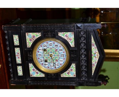 An Aesthetic movement ebonised and ceramic mounted striking table clock