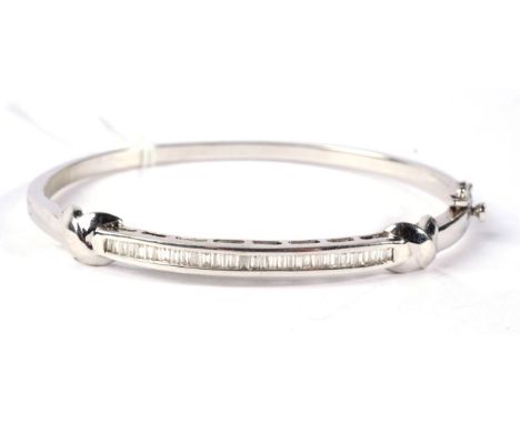 A diamond bangle, the front channel set with baguette cut diamonds, between 'X' motifs, total estimated diamond weight 0.60 c