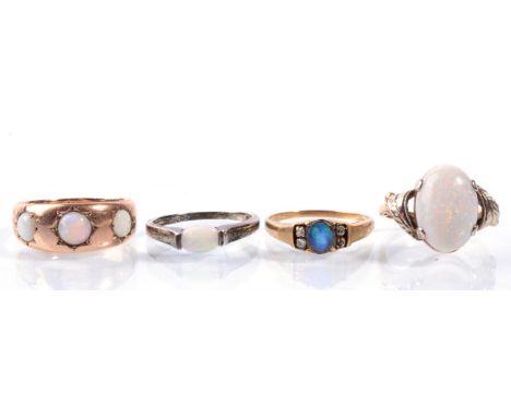 Four opal rings, including a Victorian opal three stone ring, stamped '9CT'; an opal ring, stamped '9C'T; an opal doublet and