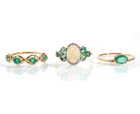 A 9 carat gold opal and emerald ring, finger size Q1/2 a 9 carat gold emerald and diamond half hoop ring and a 9 carat gold e