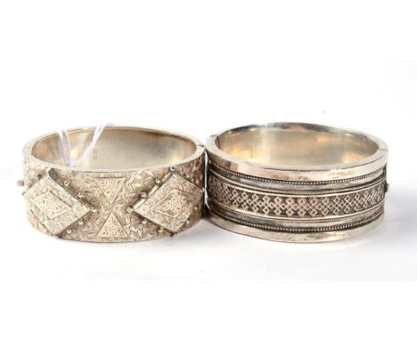 A Victorian silver cuff bangle, the front applied plaques with beaded edges, with overall chased decoration, measures 5cm by 