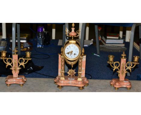 A French rough marble and gilt metal mounted striking clock garniture, late 19th century, of Portico form, Arabic dial with 8