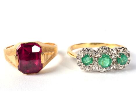 An emerald and diamond triple cluster ring, finger size R, 4.1g and a synthetic ruby ring, finger size N, 4.3g (2) 