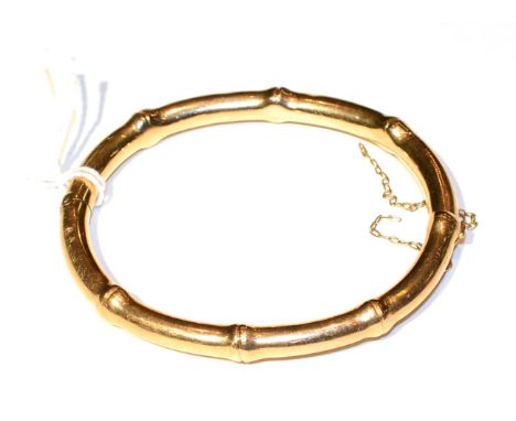 A bamboo motif bangle, measures 5cm by 6cm, stamped '15CT', 16.3g