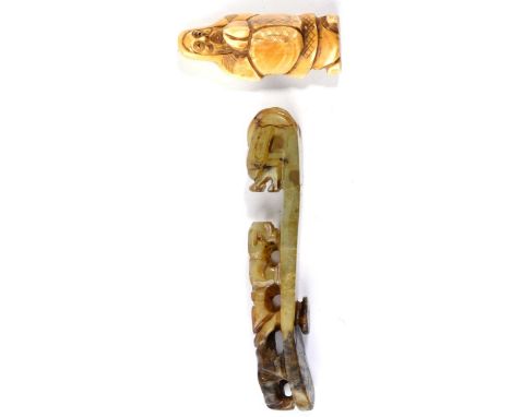 A 19th century jade type Chinese belt buckle and an early 20th century ivory netsuke