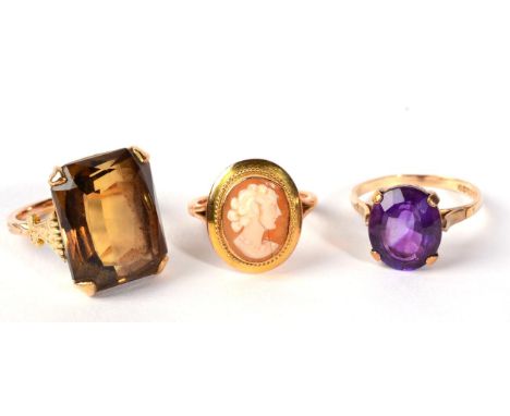 A smokey quartz dress ring finger size M; a 9 carat gold amethyst ring, finger size O and a cameo ring, 13.9g gross (3)