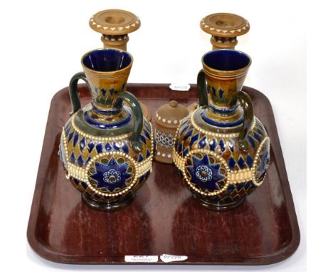 A pair of Royal Doulton Lambeth stoneware twin handled vases; two candlesticks; and a match stick holder (5) 