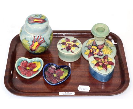 Moorcroft pottery Columbine pattern items comprising: ginger jar and cover; candlestick; two lidded boxes; and two Magnolia p