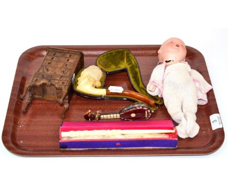 A miniature chest on stand, a carved ivory pipe, early 20th century, a cased smoking pipe depicting a Prussian soldier, a bis