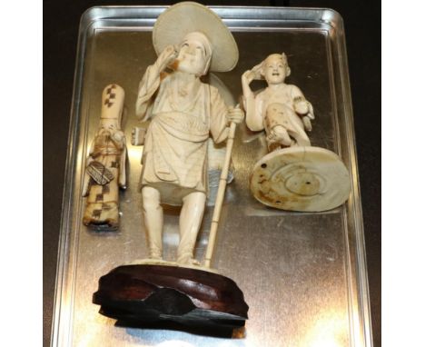 An early 20th century Japanese ivory okimono of peasant with staff; an okimono of a child (similar date) and a late 19th cent