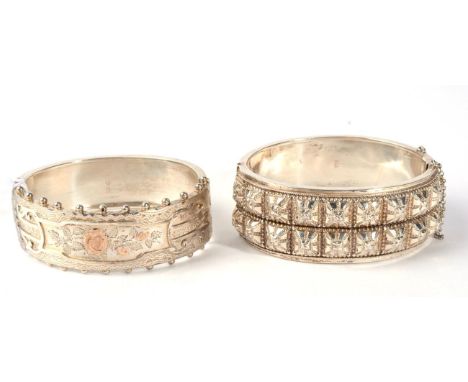A Victorian silver cuff bangle, the front with a raised square motif, measures 4.8cm by 5.8cm inner diameter, 2.5cm wide and 