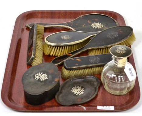 A silver mounted tortoiseshell dressing table set, Cole Brothers, London 1915/16, with silver inlay monogram, comprising: a t