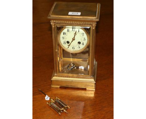 A brass four glass mantel clock with twin tube mercury pendulum 