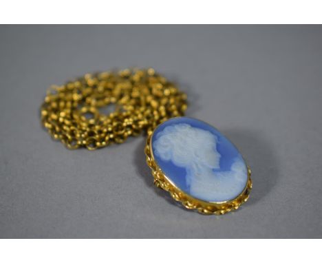An 18 Carat Mounted Jasperware Cameo Brooch Pendant, on 9 Carat Gold Chain. Pendant - 3.8gms, Chain - 5.8gms 