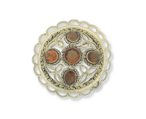 A silver-gilt and citrine plaid brooch/pendant, 19th centuryOf circular domed form with foliate and pierced Celtic style deco