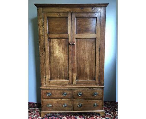 A 19th century French fruitwood armoireThe moulded cornice above the twin panelled doors enclosing a hanging rail, above four