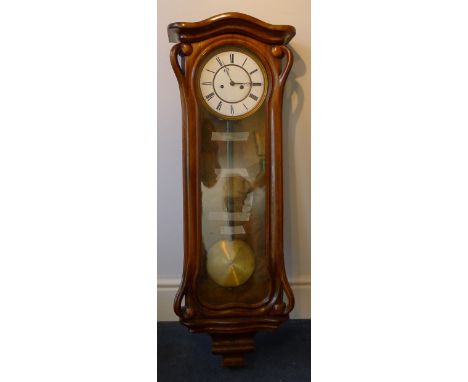 A 19th century Art Nouveau walnut framed eight day Vienna wall clockThe white enamelled dial with Roman numerals and twin win