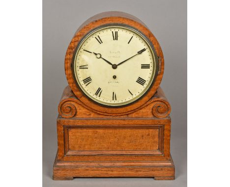 A Victorian oak cased bracket clockThe white dial with Roman numerals inscribed Arnold 8? Strand, London, enclosing the brass