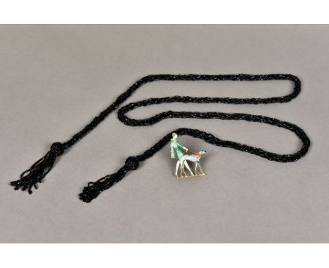An Art Deco enamel decorated broochFormed as a stylish lady walking a dog; together with an early 20th century black glass be