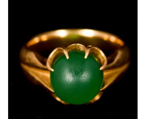 An unmarked gold and jade ringSet with a single jade cabochon.    CONDITION REPORTS:  Some general surface wear. Ring size H/