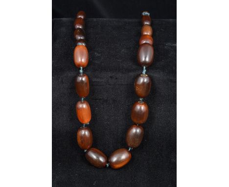 A Chinese carved horn graduated bead necklaceSecured with a jade toggle.  58 cm long.    CONDITION REPORTS:  Generally in goo