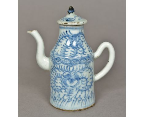 An 18th century Chinese teapotOf slender form with removable lid and scroll handle, decorated in the round with floral sprays