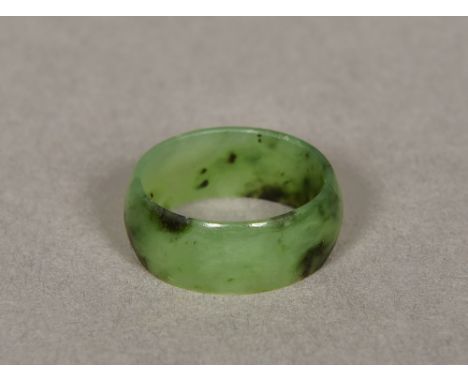 A small spinach jade ringOf band form.  8mm deep.   CONDITION REPORTS:  Generally in good condition, some general wear. 