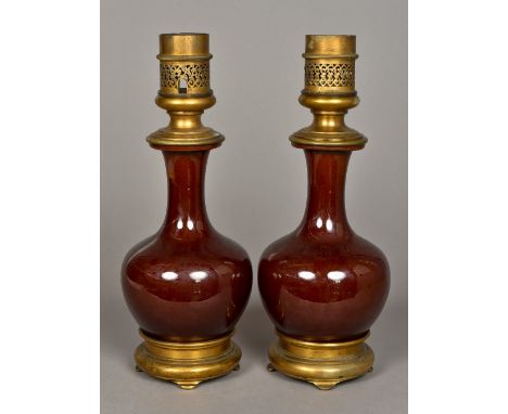 A pair of Chinese porcelain baluster vasesWith allover reddish/brown glaze, later gilt metal mounted as lamp bases.  40 cm hi