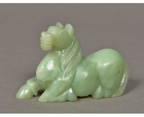 A Chinese carved jade horseModelled recumbent.  9.5 cm long.    CONDITION REPORTS:  Generally in good condition, some general