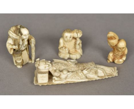 A 19th century carved ivory model of GuanyinLaying on a neck rest, a small boy beside her; together with three Japanese ivory